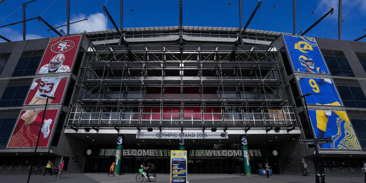 Exterior of a stadium featuring large banners of football players and welcome sign